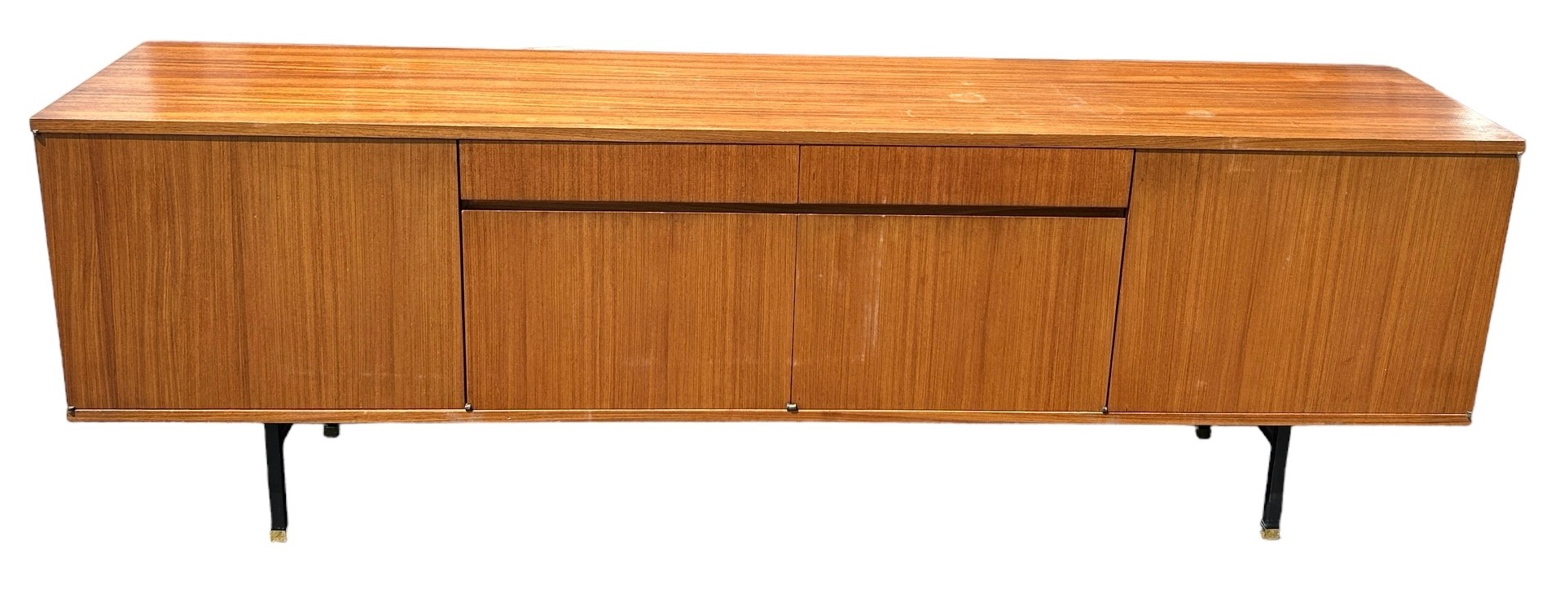 A MID CENTURY TEAK SIDEBOARD, four opening compartments and two central drawers. The compartments