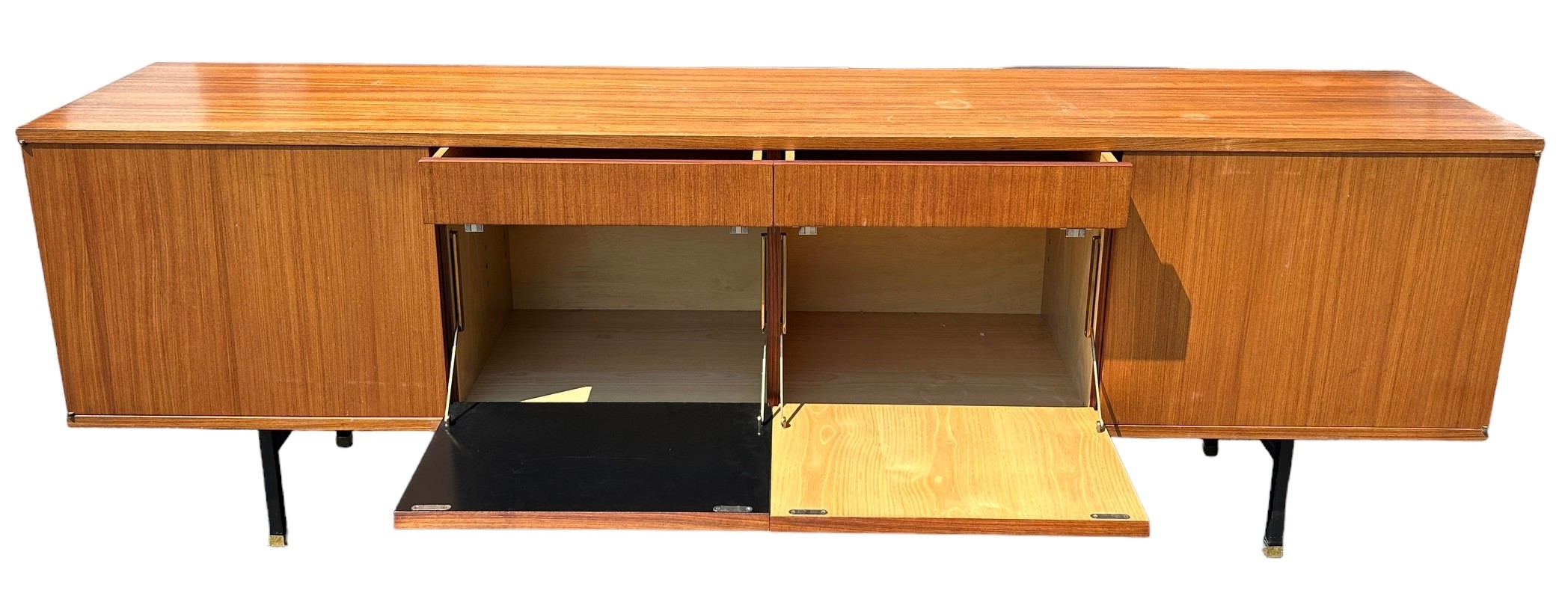 A MID CENTURY TEAK SIDEBOARD, four opening compartments and two central drawers. The compartments - Image 7 of 10