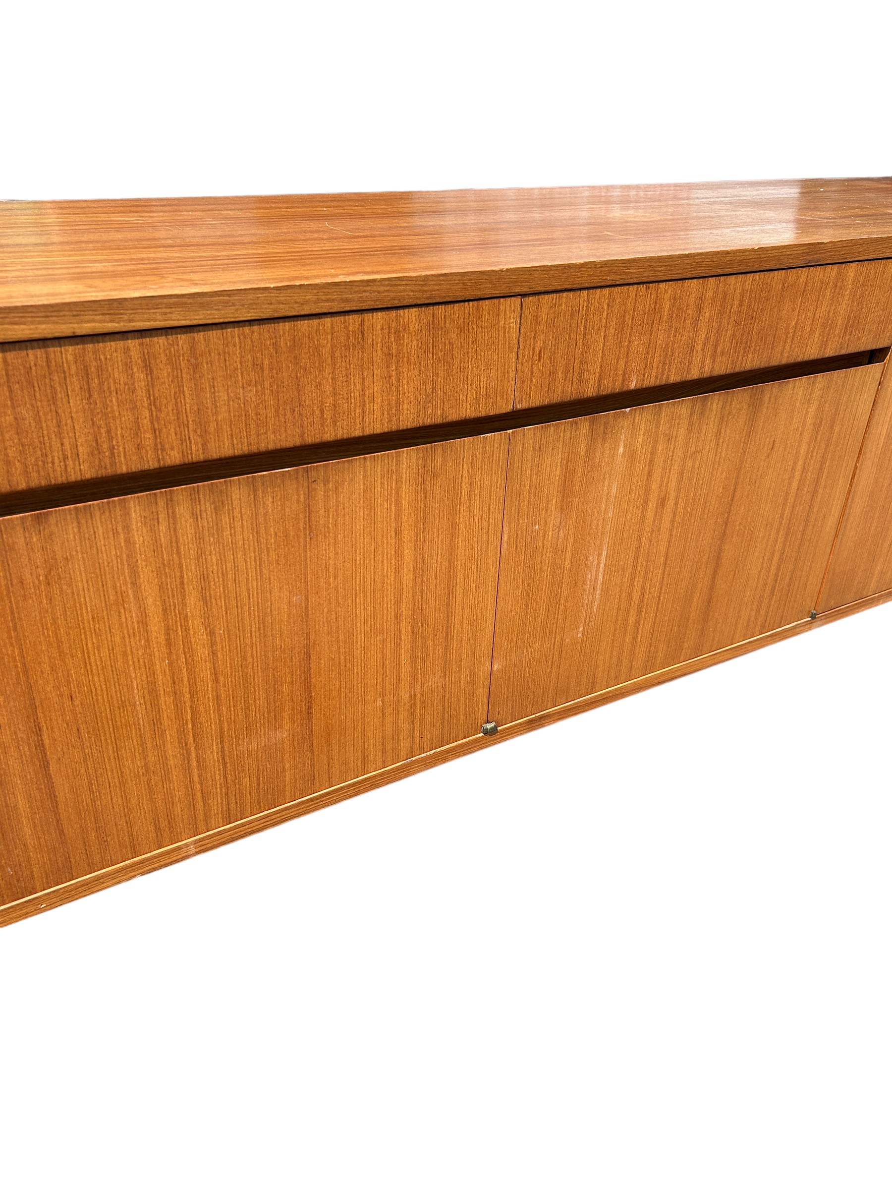 A MID CENTURY TEAK SIDEBOARD, four opening compartments and two central drawers. The compartments - Image 2 of 10