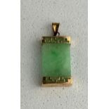 A SMALL 14CT GOLD MOUNTED NEPHRITE PENDANT, Weight: 2.4gms Marked 14KT 585 15mm drop