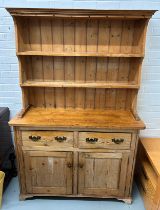 A PINE KITCHEN DRESSER, Two shelves above two drawers and cupboards. 193cm x 128cm x 43cm