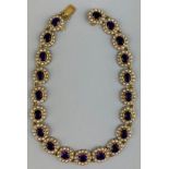 A LARGE VICTORIAN 9CT GOLD AMETHYST AND SEED PEARL NECKLACE, Twenty individual clusters of amethysts