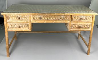 A LIMED WOOD AND CANE DRESSING TABLE WITH GLASS TOP, Five drawers raised upon four carved acanthus