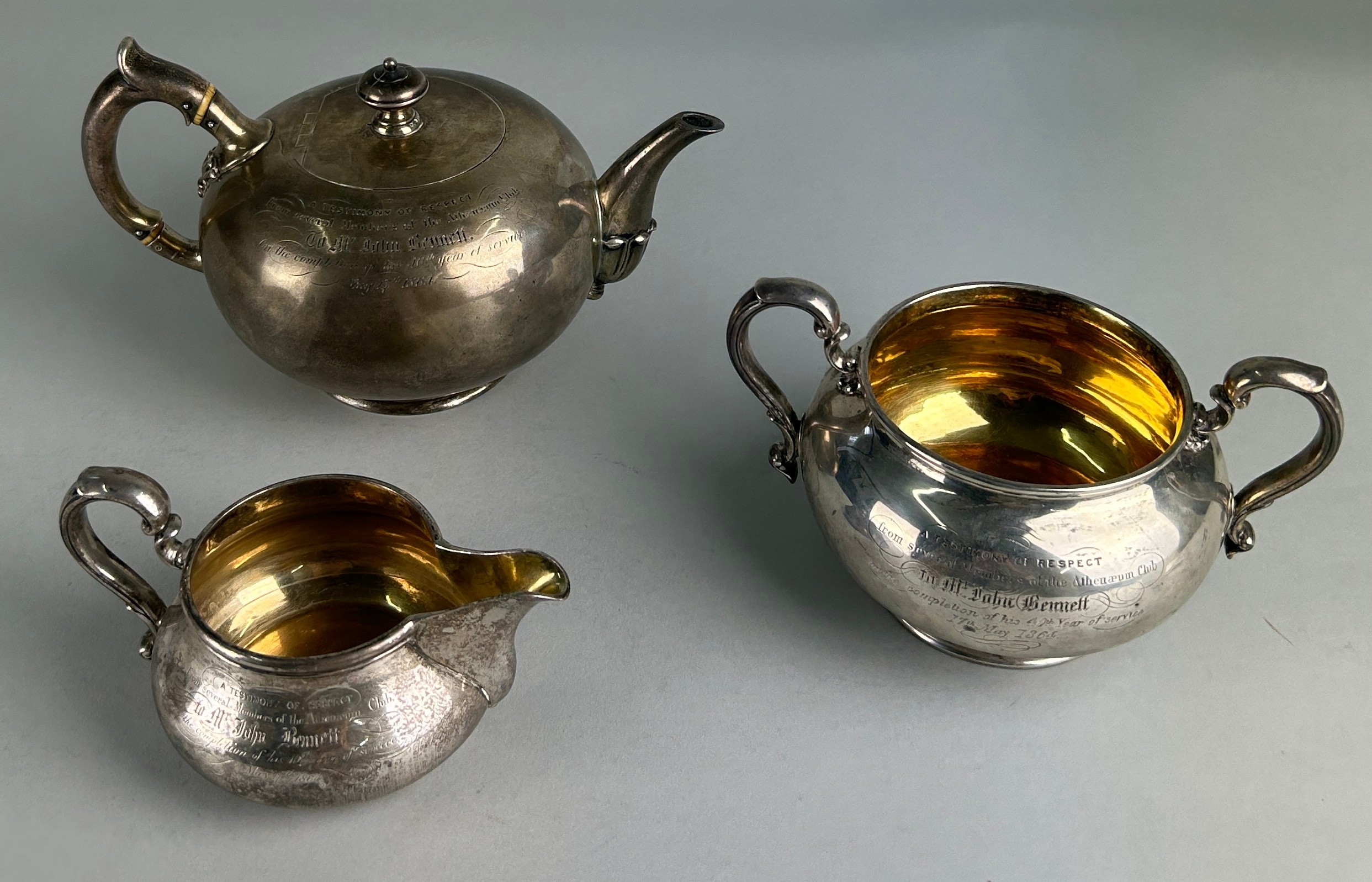 A SILVER AND GILT TEA SET BY ROBERT GARRARD II GIFTED FROM THE ATHENEUM CLUB IN PALL MALL TO THE