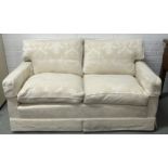 A TWO-SEATER CONTEMPORARY WHITE SOFA UPHOLSTERED IN LINEN FABRIC WITH BIRD AND FOLIAGE PATTERN.