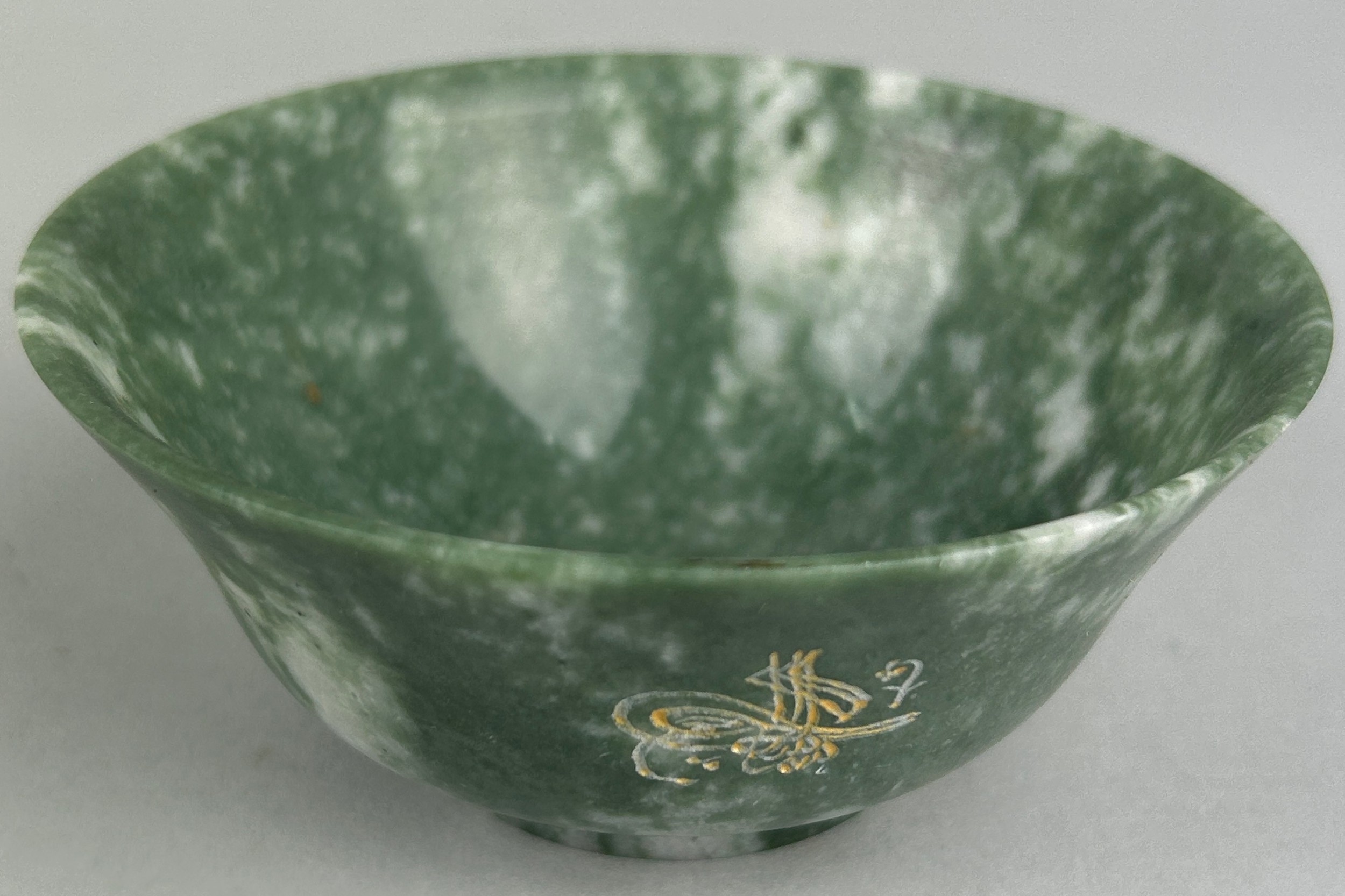 AN OTTOMAN JADE DISH WITH FLARED RIM AND CIRCULAR FOOT, Engraved with Islamic text to one side,