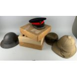 A GROUP OF THREE MILITARY HELMETS, to include one in an old Moss Bros box (4)