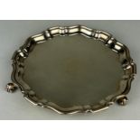 A SILVER TRAY BY HUKIN AND HEATH, Pie crust border raised on fern frond feet. Weight 297gms