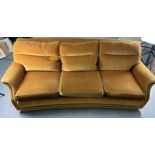 A MID CENTURY DESIGN THREE-SEATER SOFA The curved frame upholstered in green velvet fabric, raised