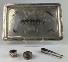 A PERSIAN SILVER TRAY ALONG WITH TWO NAPKIN RINGS AND TONGS (4), All engraved with images of