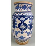 AN ISLAMIC PHARMACY JAR BLUE AND WHITE PAINTED WITH FLOWERS, 21cm in height
