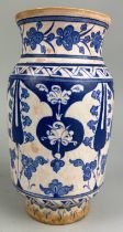 AN ISLAMIC PHARMACY JAR BLUE AND WHITE PAINTED WITH FLOWERS, 21cm in height