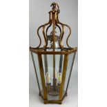 A HEXAGONAL HANGING CEILING LANTERN, with glass sides raised on roundels. 52cm H