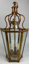 A HEXAGONAL HANGING CEILING LANTERN, with glass sides raised on roundels. 52cm H