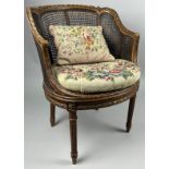 A FRENCH CANED BERGERE WITH NEEDLEPOINT UPHOLSTERED SEAT AND CUSHION OF FOLIATE DESIGN 80cm x 60cm x