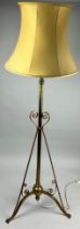 A TELESCOPIC ART NOUVEAU BRASS TRIPOD STANDARD LAMP WITH SCROLLS AND ROUNDELS, 135cm H