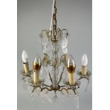 A SMALL BRASS AND GLASS CHANDELIER WITH CRYSTAL DROPS,