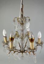 A SMALL BRASS AND GLASS CHANDELIER WITH CRYSTAL DROPS,