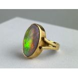 A GOLD RING INSET WITH AN OPAL, Total weight 6.6gms 23mm x 20mm