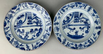 A PAIR OF CHINESE KANGXI PERIOD (1662-1722) 'CHICKEN DISHES', Blue and white painted with scenes
