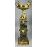 A LARGE EMPIRE DESIGN GREEN MARBLE COLUMN WITH GILT BRONZE CAMPAGNA URN AND GROTESQUE MOUNTS,