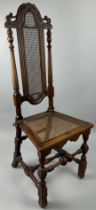A WILLIAM AND MARY WALNUT SIDE CHAIR, The high back with caned central panel raised on four legs.