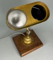 A DUGDILLS PATENT INDUSTRIAL LAMP, 30cm h x 30cm w On wooden stand.
