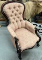 A VICTORIAN SPOON BUTTON BACK ARMCHAIR UPHOLSTERED IN PINNK FLORAL FABRIC, Two front cabriole arms