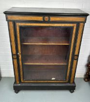 A VICTORIAN EBONISED CABINET FITTED WITH BURNT ORANGE PAINTED BORDERS, A swing glass door opening to