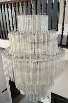 A NOVARESI ITALIAN MURANO GLASS CHANDELIER, With five tiers of individual glass shades on a chrome