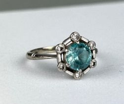 AN 18CT WHITE GOLD RING inset with an blue topaz stone mounted in a hexagonal setting with six