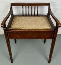 AN ANTIQUE PIANO STOOL WITH UPHOLSTERED SEAT