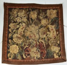 A 17TH CENTURY TAPESTRY FRAGMENT DEPICTING FLOWERS 55cm x 55cm