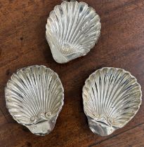 A SET OF THREE SILVER OYSTER SHELL BUTTER DISHES INCLUDING A PAIR BY WALTER AND CHARLES SISSONS,