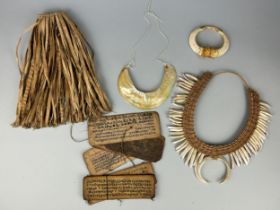 A COLLECTION OF TRIBAL ARTEFACTS MADE FROM SHELL, BONE AND TOOTH FROM PAPUA NEW GUINEA AND PRAYER