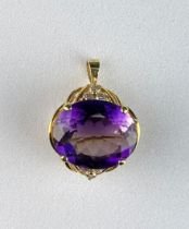 AN AMETHYST AND 18CT GOLD BROOCH WITH SMALL DIAMOND SET SHOULDERS. Insurance valuation from Philip