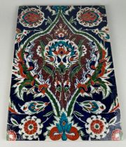 A LARGE IZNIK GLAZED TILE PAINTED WITH FLORAL SPRAYS, 49cm h x 33cm w