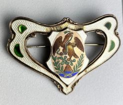 AN ART NOUVEAU ENAMEL AND STERLING SILVER BROOCH WITH A GRIFFIN CENTREPIECE. Some damage