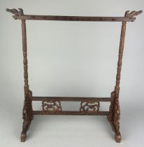 A 20TH CENTURY CHINESE HARDWOOD TABLE TOP STAND, With reticulated sides and front, and eight hanging