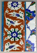 A SMALL IZNIK TILE DECORATED WITH FLOWERS, 24. 5cm h x 17cm w