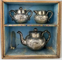 A CHINESE EXPORT SILVER TEA SET WITH FOUR CLAWED DRAGONS MARKED HC MOST PROBABLY HUNG CHONG AND CO