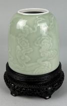 A CHINESE CELADON BRUSH POT, 12cm h x 11.5cm diameter of base Incised with clouds and smoke