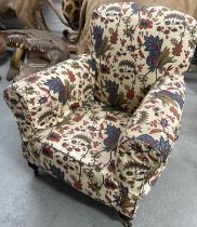 A FLORALLY UPHOLSTERED ARMCHAIR, two rounded front castors and two squared back castors, 89cm w x