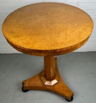 A 19TH CENTURY CONTINENTAL BIEDERMEIER OCCASCIONAL TABLE, The circular top raised upon an