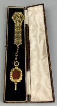 VICTORIA CROSS MEDAL MEMORABILIA: AN ORNATE 15CT GOLD POCKET WATCH FOB WITH CENTRAL RED CARNELIAN