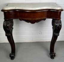 A GEORGIAN DESIGN CONSOLE TABLE WITH WHITE MARBLE TOP, Two legs heavily carved with acanthus leaves.