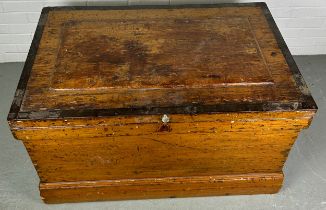 A LARGE 19TH CENTURY PINE CARPENTERS TRUNK,1 02cm x 63cm x 60cm The rising lid opening to reveal a
