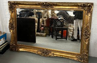 A VERY LARGE MODERN GILTWOOD MIRROR