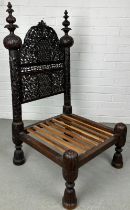 A 19TH CENTURY INDIAN PIDDHA CHAIR, Heavily carved hardwood possibly Bombay wood, very low wooden