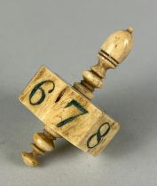 GAMBLING INTEREST: AN ANTIQUE BONE SPINNING TOP WITH NUMBERS